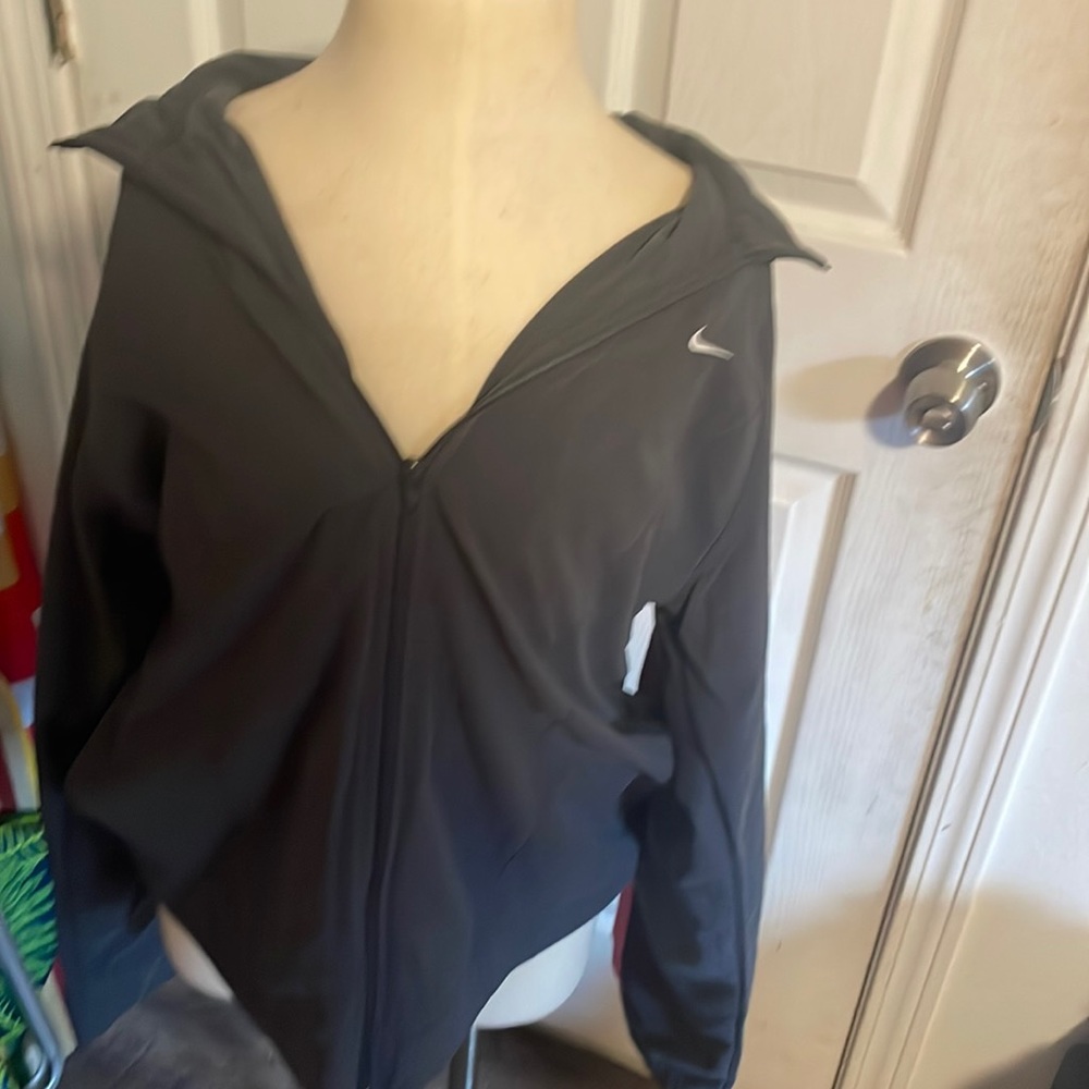 Pink and grey Nike tracksuit jacket.